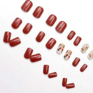 Sparkly red Christmas press-on nails with Santa and reindeer festive nail art