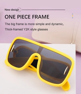 Close-up of yellow Y2K sunglasses featuring a thick one-piece frame and oversized lens