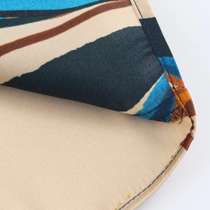 Detailed macro view of abstract floral printed fabric with precise double-needle stitching