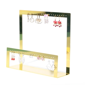 Detailed view of an L-shaped gold metal earring display stand with multi-hole design