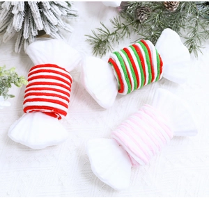 Detail shot of red and white striped candy shaped hair ties with festive pine cones