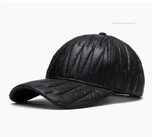 Detail of black quilted puffer baseball cap showing insulated texture and windproof fabric