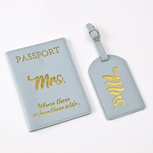 Detail of light blue PU leather passport holder and luggage tag set with gold foil text