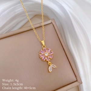 Detail of pink flower necklace with white zircon leaves on a luxury jewelry box