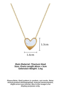 Close-up of gold titanium heart necklace with white shell inlay and 1.6cm pendant size