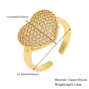 Detail view of heart-shaped gold ring with pave zircons and dimension markings