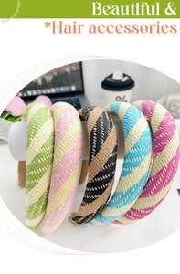 Close-up of five woven candy-colored headbands with textured patterns on a white stand
