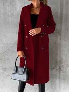 Detail of burgundy wool coat showing double-breasted buttons and classic lapel texture