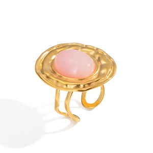 Macro detail of French vintage gold ring with textured finish and pink natural stone