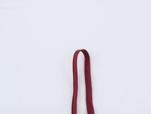 Detailed macro view of dark red jacquard fabric strap with delicate sequin accents
