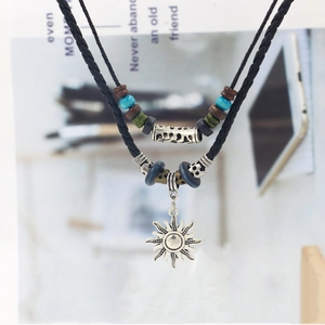 Vintage bohemian leather sun pendant necklace with double layered beads and woven rope design