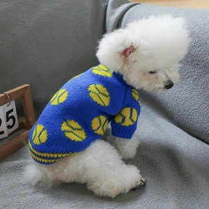 Detail of blue pet knit sweater with yellow tennis patterns on a Bichon Frise