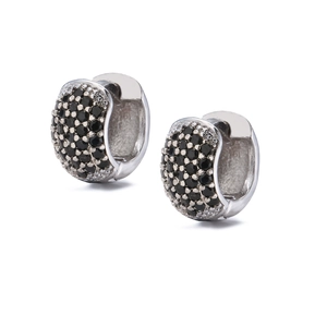 Detail view of silver huggie earrings featuring pave-set black round cubic zirconia stones