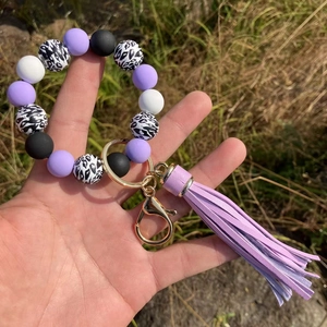 Detailed shot of silicone beaded keychain bracelet with purple tassel and leopard beads