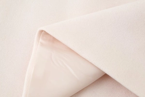 Detail of pink wool fabric texture and smooth silk lining with premium sewing craftsmanship