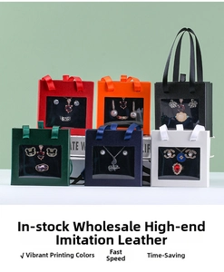 Luxe faux leather jewelry bags with silk handles and window showing necklace set