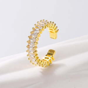 Macro shot of gold-plated adjustable ring featuring baguette-cut clear zircon stones