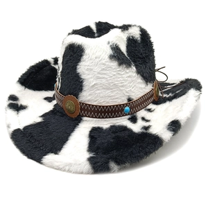 Close-up of cow print cowboy hat featuring a braided leather band with turquoise beads
