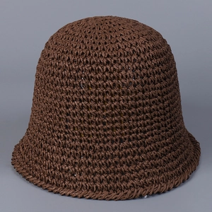 Close-up of dark brown woven straw bucket hat showing detailed texture and flexible fiber