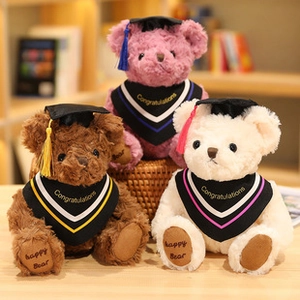 Three plush graduation teddy bears in pink, brown and white with black caps and gowns