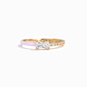 Detail of gold ring with purple enamel, rectangular zircon center and pavé settings