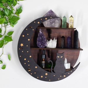 Detail view of crescent moon crystal shelf with cat silhouette and stars on white wall