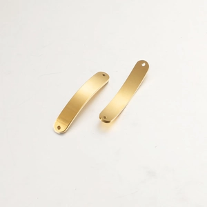 Detail of two curved golden stainless steel bar connectors with a brushed metal surface