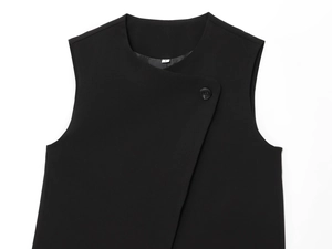 Detail of black double-breasted vest neckline with S-size label on woven fabric