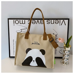 Detail of canvas tote bag featuring cute panda print and durable brown shoulder straps