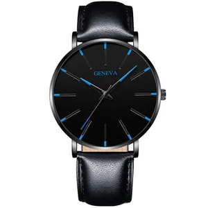 Detail of minimalist black dial watch with contrasting blue markers and leather strap