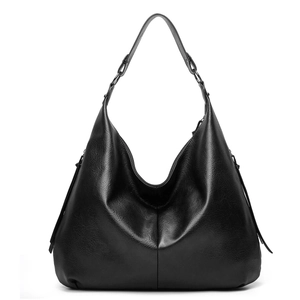 Detail of black soft leather hobo shoulder bag with smooth texture and metal rings