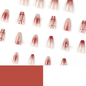 Red gradient press-on nails with heart prints, plaid patterns and rhinestones