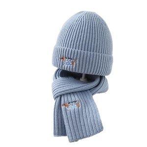Kids knitted light blue hat and scarf set with embroidered dachshund for winter warmth