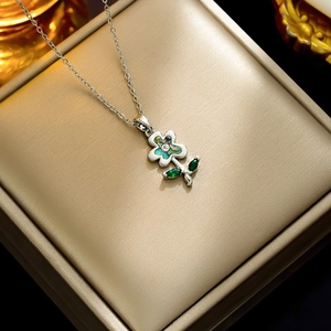 Silver flower pendant necklace with colorful shell inlay and green gemstone leaves