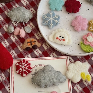 Detailed view of handmade wool felt ornaments in Christmas tree and cloud shapes