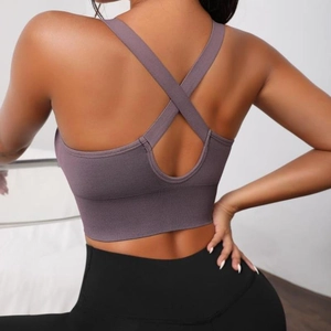 Seamless purple sports bra for women featuring a supportive racerback and ribbed knit hem