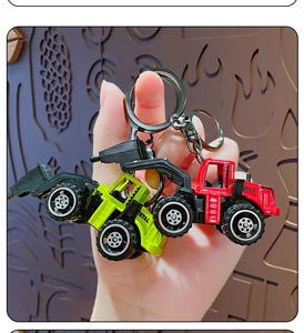 Detail of mini alloy construction truck keychains in red and neon green with metal rings