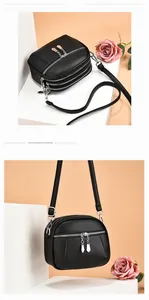 Detail of black lychee grain PU leather crossbody bag featuring a triple-zipper storage design