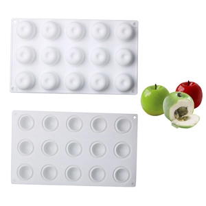 Detail of white silicone apple mold showing cavity texture and finished mousse cakes