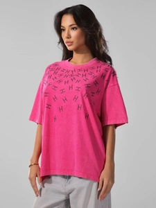 Detail of pink vintage washed cotton T-shirt featuring black letter H monogram pattern