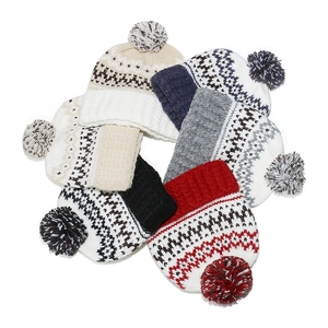 Fair Isle bohemian knit beanies with geometric patterns and large colorful pom-poms
