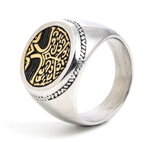 Detail of vintage silver men's ring showing circular gold face with intricate pattern