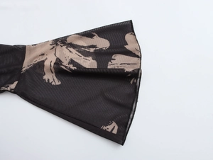 Close-up of floral print mesh fabric detail on semi-high collar bodycon dress sleeves