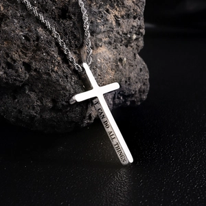Polished silver stainless steel cross pendant necklace with engraved text on volcanic rock