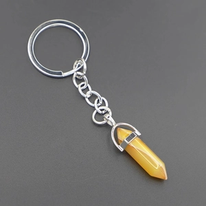 Macro detail of hexagonal yellow agate stone pendant with silver metal keychain