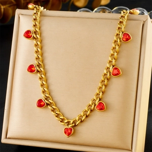 Detail of gold-plated stainless steel chain necklace with sparkling red heart crystals