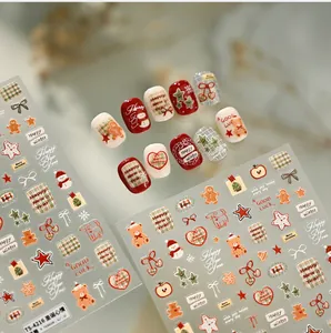 Détail de stickers à ongles de Noël avec ours mignon, bonhomme de neige et motifs écossais