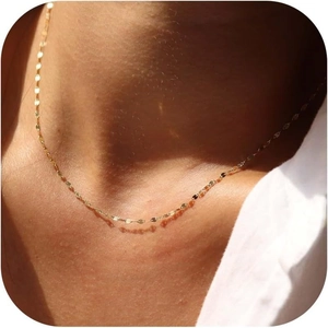 Detailed view of an 18k gold-plated stainless steel chain necklace worn on a model's neck