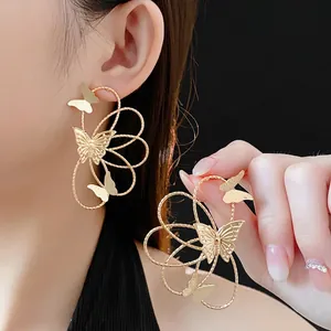 Elegant gold hollow butterfly drop earrings with spiral hoops and silver needles for women