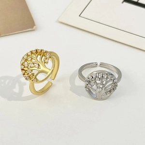 Detail of tree of life open rings in gold and silver finish with zircon inlay